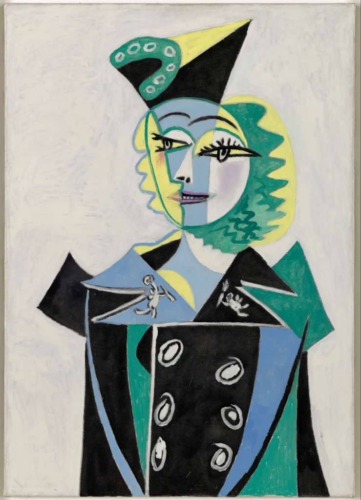 Pablo Picasso, Portrait of Nusch Eluard, 1937. Olej na plátne, kubistický portrét ženy v čiernom kabáte so zelenými a žltými tónmi.
