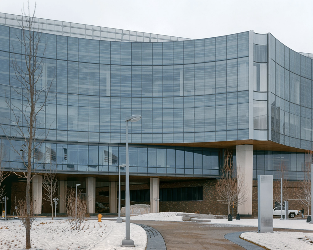 Zakrivená sklenená fasáda Ford World Headquarters od Snøhetty s oválnymi presklenými balkónmi v Dearborne v Michigane