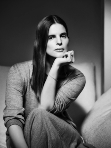 Čiernobiely portrét Catherine Holstein s rukou opretou o bradu