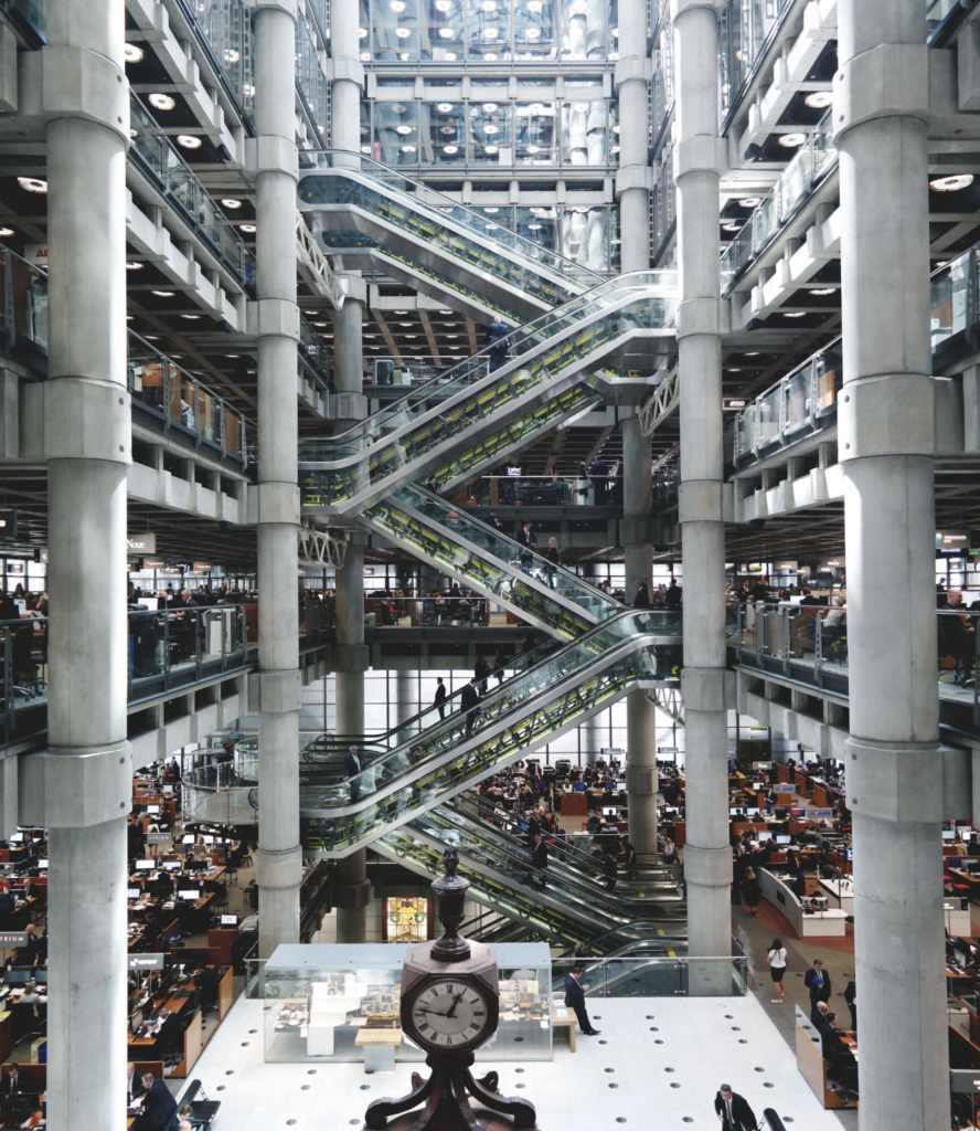 Centrálne atrium budovy Lloyd's of London s eskalátormi a klasickými hodinami